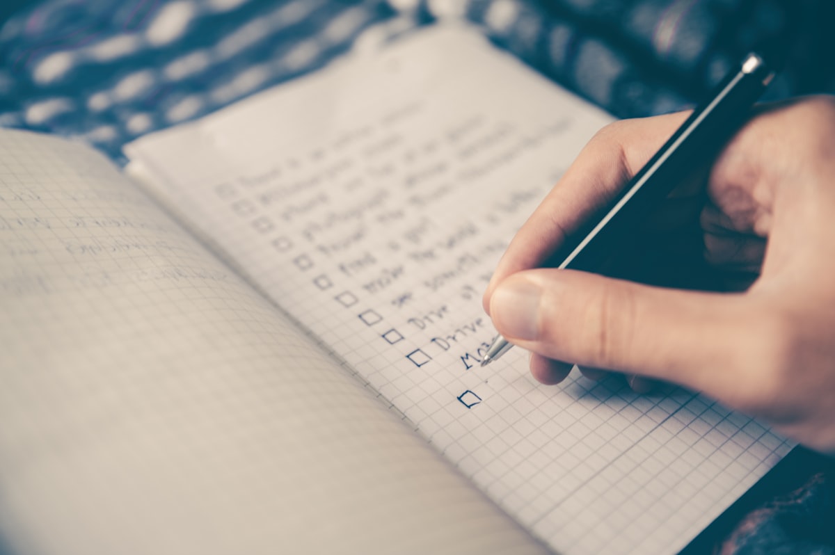 Open notebook with handwritten notes on a desk next to a cup of coffee