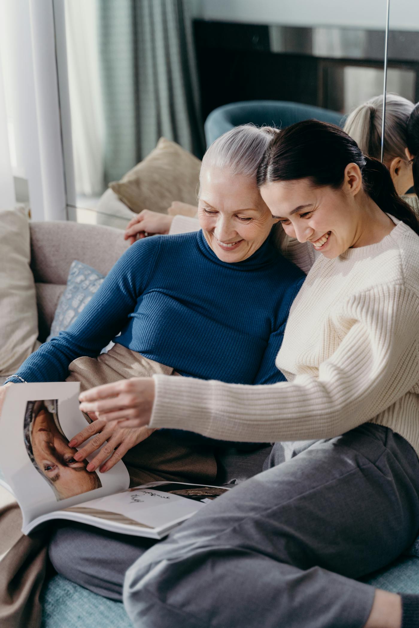 Worried adult daughter sitting with elderly mother, showing the emotional weight of caregiving