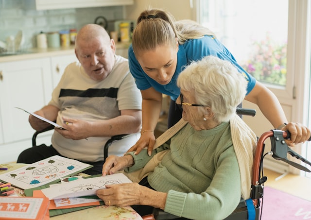 Adult daughter smiling with her elderly mother at home