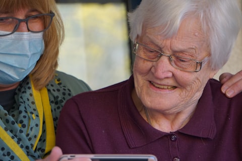 Family gathered together looking at a tablet